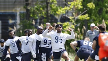 May 23, 2024; Lake Forest, IL, USA; Chicago Bears defensive end DeMarcus Walker (95) warms up during organized team activities at Halas Hall Mandatory Credit: Kamil Krzaczynski-Imagn Images