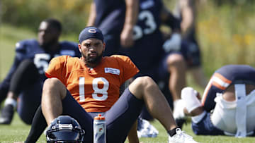 Aug 8, 2025; Lake Forest, IL, USA; Chicago Bears quarterback Caleb Williams (18) sits on the field during joint training camp practice with the Miami Dolphins ahead of Sunday's preseason opener. Mandatory Credit: Kamil Krzaczynski-Imagn Images