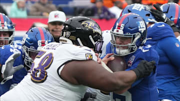 East Rutherford, NJ -- December 15, 2024 -- Michael Pierce of the Ravens hits Tommy DeVito of the Giants taking a late hit penalty in the first half. The Baltimore Ravens came to MetLife Stadium to play the New York Giants.