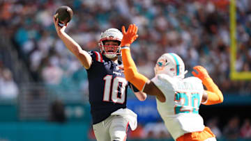 Nov 24, 2024; Miami Gardens, Florida, USA; New England Patriots quarterback Drake Maye (10) attempts a pass over Miami Dolphins linebacker Jordyn Brooks (20) during the first half at Hard Rock Stadium. Mandatory Credit: Jasen Vinlove-Imagn Images