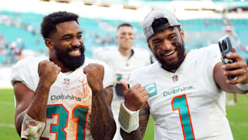 Dec 17, 2023; Miami Gardens, Florida, USA; Miami Dolphins quarterback Tua Tagovailoa (1) and running