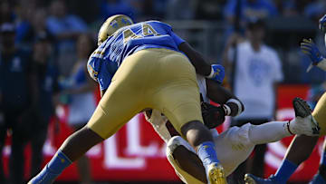 Nov 24, 2018; Pasadena, CA, USA; UCLA Bruins defensive line Martin Andrus Jr. (44) tackles Stanford Cardinal running back Bryce Love (20) for a safety during the second half at Rose Bowl. Mandatory Credit: Kelvin Kuo-Imagn Images