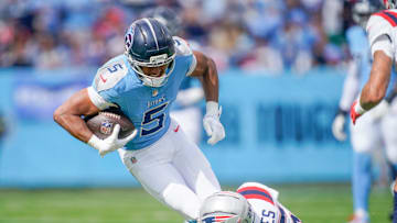 Tennessee Titans wide receiver Elic Ayomanor (5) is tripped up by New England Patriots cornerback Marcus Jones (25) during the first quarter at Nissan Stadium in Nashville, Tenn., Sunday, Oct. 19, 2025.