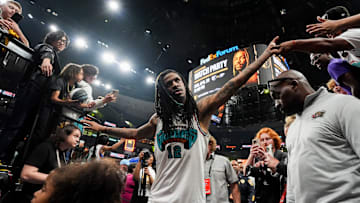 Grizzlies' Ja Morant (12) high fives fans as he walks off the court after the Grizzlies defeated the Mavericks 120-106 in the play-in game to secure a spot in the NBA Playoffs at FedExForum in Memphis, Tenn., on Friday, April 18, 2025.