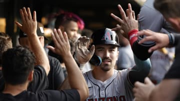 Jul 20, 2024; Chicago, Illinois, USA; Arizona Diamondbacks outfielder Corbin Carroll (7) celebrates with teammates in the dugout after hitting a two-run home run against the Chicago Cubs during the fifth inning at Wrigley Field. Mandatory Credit: Kamil Krzaczynski-USA TODAY Sports