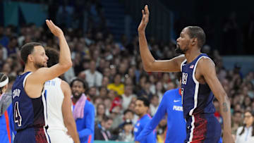 Aug 3, 2024; Villeneuve-d'Ascq, France; United States guard Kevin Durant (7) celebrates with shooting guard Stephen Curry (4) in the second quarter against Puerto Rico during the Paris 2024 Olympic Summer Games at Stade Pierre-Mauroy. Mandatory Credit: John David Mercer-Imagn Images