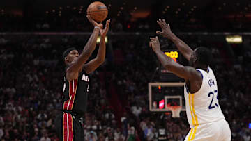 Nov 1, 2022; Miami, Florida, USA; Miami Heat forward Jimmy Butler (22) shoots the ball over Golden State Warriors forward Draymond Green (23) during the second half at FTX Arena. Mandatory Credit: Jasen Vinlove-Imagn Images
