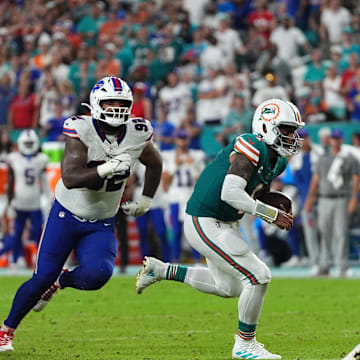 Miami Dolphins quarterback Tua Tagovailoa (1) scrambles with the ball against the Buffalo Bills during the second half at Hard Rock Stadium.