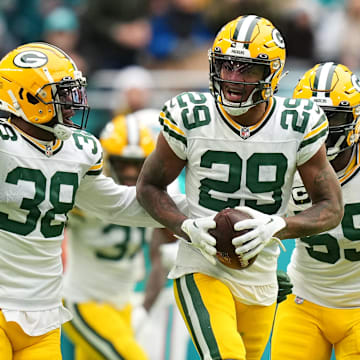 Green Bay Packers cornerback Rasul Douglas (29) celebrates with teammates after intercepting a pass from Miami Dolphins quarterback Tua Tagovailoa (not pictured) during the second half at Hard Rock Stadium on Christmas Day 2022.