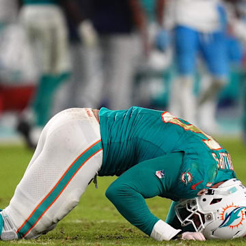 Sep 30, 2024; Miami Gardens, Florida, USA; Miami Dolphins linebacker Jaelan Phillips (15) reacts after an apparent injury during the second half against the Tennessee Titans at Hard Rock Stadium. 