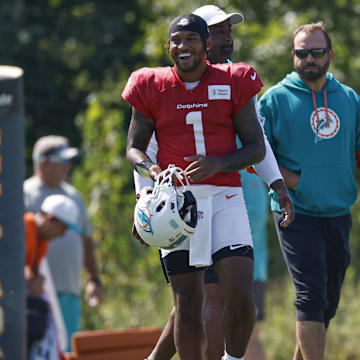 Miami Dolphins quarterback Tua Tagovailoa (1) walks on the field during joint training camp practice with the Chicago Bears ahead of Sunday's preseason opener.