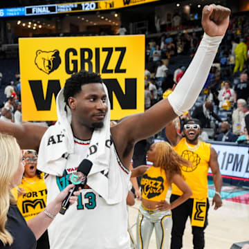 Grizzlies' Jaren Jackson Jr. (13) celebrates as he’s interviewed in front of a Grizzlies hype crew after the Grizzlies defeated the Mavericks 120-106 in the play-in game to secure a spot in the NBA Playoffs at FedExForum in Memphis, Tenn., on Friday, April 18, 2025.