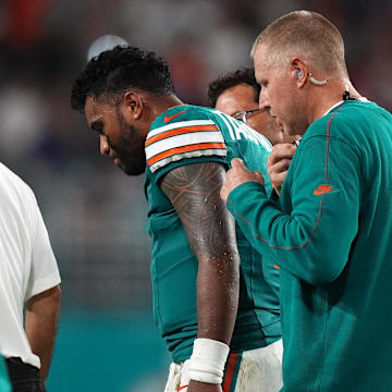 Sep 12, 2024; Miami Gardens, Florida, USA; Miami Dolphins quarterback Tua Tagovailoa (1) walks off the field with training staff after an apparent injury during the second half against the Buffalo Bills at Hard Rock Stadium. Mandatory Credit: Jasen Vinlove-Imagn Images