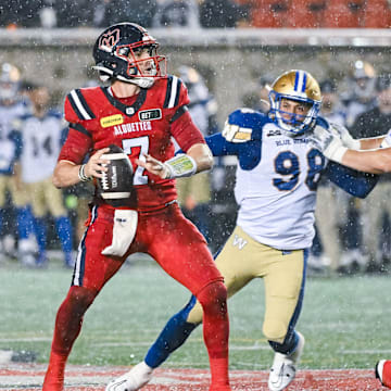 Jul 1, 2023; Montreal, Quebec, CAN; Montreal Alouettes quarterback Cody Fajardo (7) considers his options with the ball against the Winnipeg Blue Bombers during the fourth quarter at Percival Molson Memorial Stadium. Mandatory Credit: David Kirouac-Imagn Images