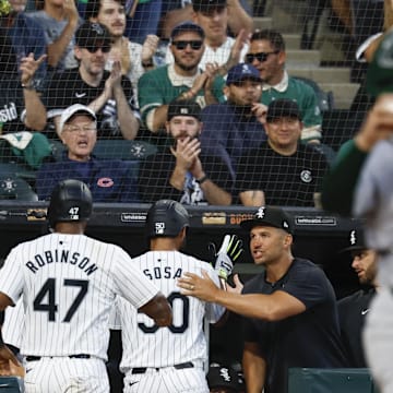 Sep 14, 2024; Chicago, Illinois, USA; Chicago White Sox interim manager Grady Sizemore (24) congratulates third baseman Lenyn Sosa (50) and catcher Chuckie Robinson (47) after they scored against the Oakland Athletics during the second inning at Guaranteed Rate Field.