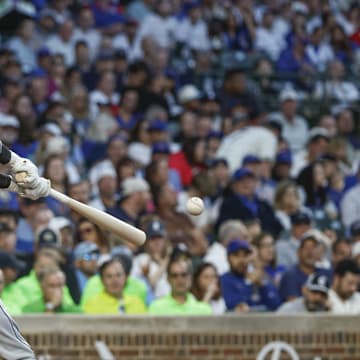 Chicago White Sox catcher Yasmani Grandal (24) singles against the Chicago Cubs during the second inning at Wrigley Field in 2023.