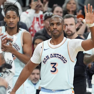 Chris Paul waves to fans after moving to #2 on the all-time assists list. 
