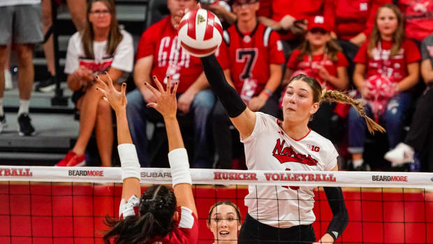 Nebraska Cornhuskers middle blocker Andi Jackson (15) attacks against Wisconsin Badgers middle blocker Caroline Crawford (9).