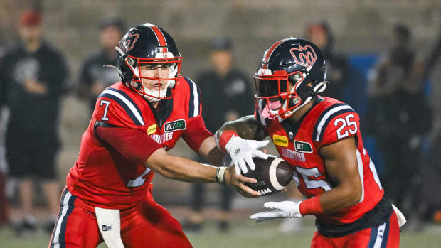 Jul 1, 2023; Montreal, Quebec, CAN; Montreal Alouettes quarterback Cody Fajardo (7) hands the ball off to running back Walter Fletcher (25) against the Winnipeg Blue Bombers during the second quarter at Percival Molson Memorial Stadium. Mandatory Credit: David Kirouac-USA TODAY Sports