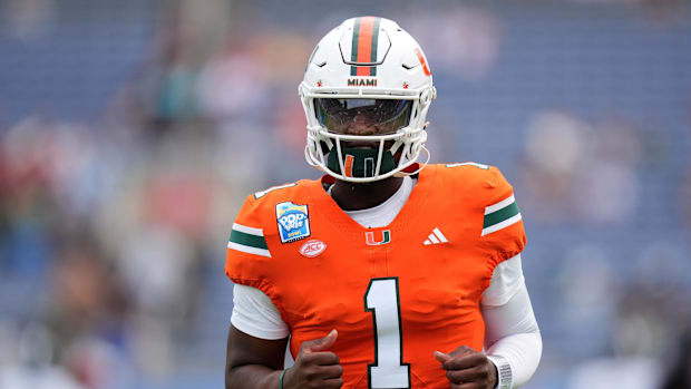 Dec 28, 2024; Orlando, FL, USA; Miami Hurricanes quarterback Cam Ward (1) warms up prior to the game against the Iowa State C