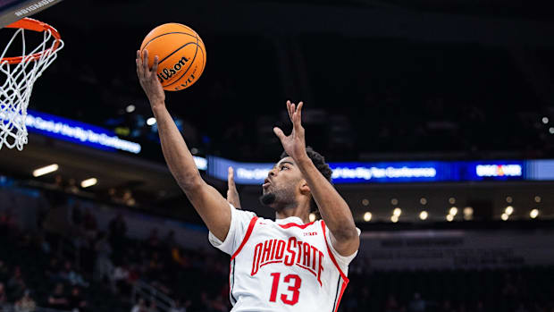 Ohio State Buckeyes forward Sean Stewart (13) shoots the ball while Iowa Hawkeyes forward Ladji Dembele (13) defends