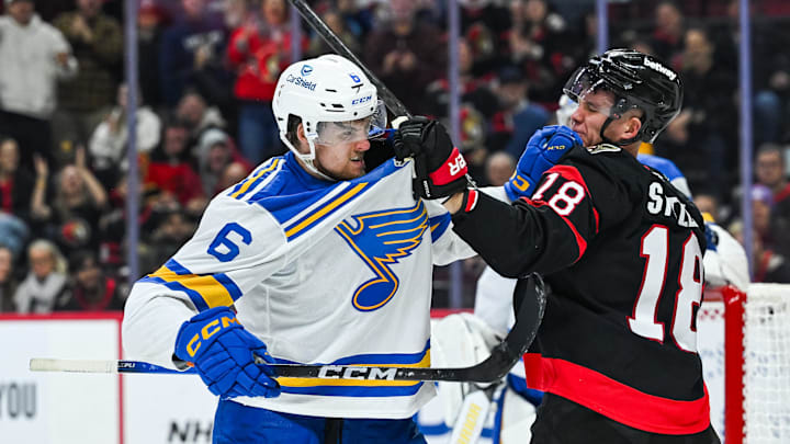 Dec 6, 2025; Ottawa, Ontario, CAN; Ottawa Senators center Tim Stutzle (18) fights St. Louis Blues defenseman Philip Broberg (6) during the third period at Canadian Tire Centre. Mandatory Credit: David Kirouac-Imagn Images