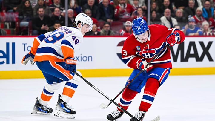 Feb 26, 2026; Montreal, Quebec, CAN; New York Islanders defenseman Matthew Schaefer (48) defends the puck against Montreal Canadiens right wing Cole Caufield (13) during overtime at Bell Centre. Mandatory Credit: David Kirouac-Imagn Images