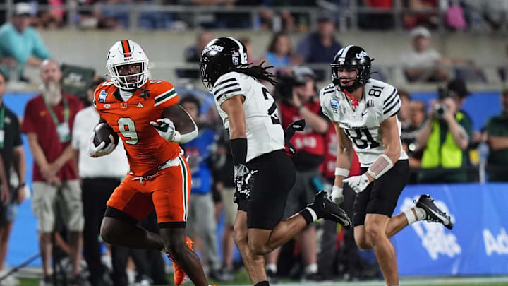 Dec 28, 2024; Orlando, FL, USA; Miami Hurricanes tight end Elija Lofton (9) runs the ball against the Iowa State Cyclones during the second half at Camping World Stadium. Mandatory Credit: Jasen Vinlove-Imagn Images