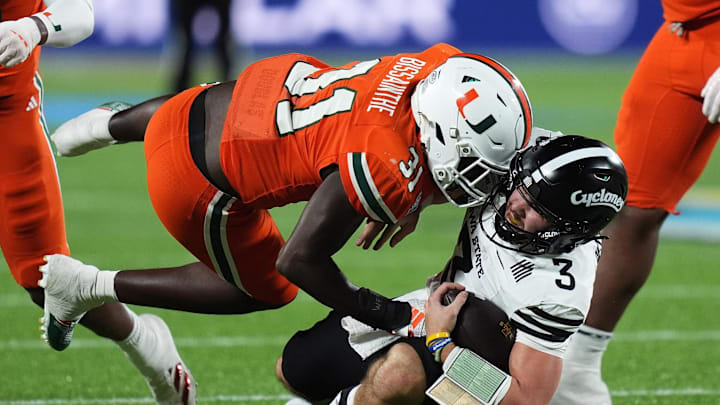 Dec 28, 2024; Orlando, FL, USA; Miami Hurricanes linebacker Wesley Bissainthe (31) tackles Iowa State Cyclones quarterback Rocco Becht (3) during the second half at Camping World Stadium. Mandatory Credit: Jasen Vinlove-Imagn Images