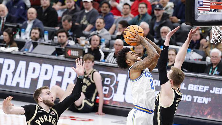Mar 14, 2026; Chicago, IL, USA; UCLA Bruins guard Donovan Dent (2) goes to the basket against Purdue Boilermakers guard Fletcher Loyer (2) during the first half at United Center. Mandatory Credit: Kamil Krzaczynski-Imagn Images