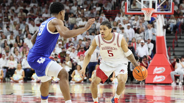 Jan 31, 2026; Fayetteville, Arkansas, USA; Arkansas Razorbacks guard Darius Acuff Jr (5) drives against Kentucky Wildcats guard Otega Oweh (00) during the second half at Bud Walton Arena. Kentucky won 85-77. Mandatory Credit: Nelson Chenault-Imagn Images