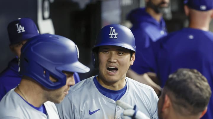 Jun 25, 2024; Chicago, Illinois, USA; Los Angeles Dodgers designated hitter Shohei Ohtani (17) celebrates with teammates in the dugout after scoring against the Chicago White Sox during the third inning at Guaranteed Rate Field. Mandatory Credit: Kamil Krzaczynski-USA TODAY Sports