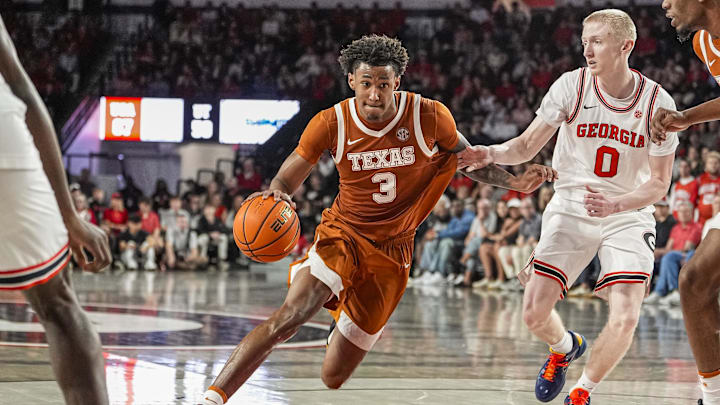 Feb 21, 2026; Athens, Georgia, USA; Texas Longhorns forward Dailyn Swain (3) dribbles against Georgia Bulldogs guard Blue Cain (0) at Stegeman Coliseum. Mandatory Credit: Dale Zanine-Imagn Images