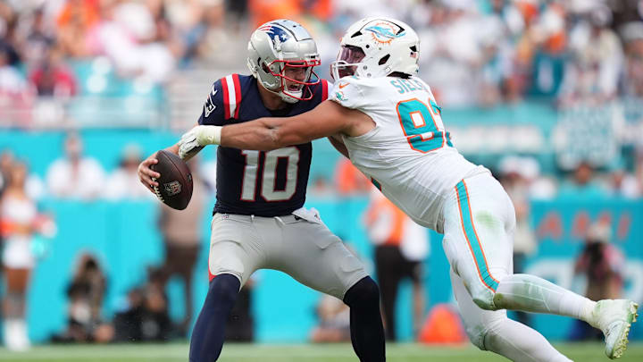 Nov 24, 2024; Miami Gardens, Florida, USA; Miami Dolphins defensive tackle Zach Sieler (92) strip sacks New England Patriots quarterback Drake Maye (10) during the second half at Hard Rock Stadium. Mandatory Credit: Jasen Vinlove-Imagn Images