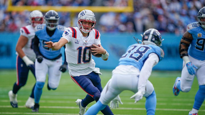New England Patriots quarterback Drake Maye (10) runs around Tennessee Titans cornerback L'Jarius Sneed (38) during the first quarter at Nissan Stadium in Nashville, Tenn., Sunday, Oct. 19, 2025.