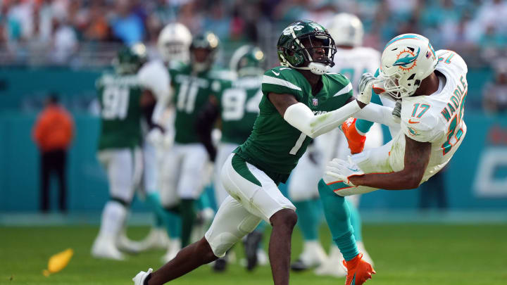 Dec 17, 2023; Miami Gardens, Florida, USA; New York Jets cornerback Sauce Gardner (1) hits Miami Dolphins wide receiver Jaylen Waddle (17) after a catch during the first half at Hard Rock Stadium. Mandatory Credit: Jasen Vinlove-USA TODAY Sports