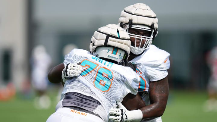 Aug 3, 2022; Miami Gardens, Florida, US; Miami Dolphins tackle Kion Smith (76) and Greg Little (75) run drills during training camp at Baptist Health Training Complex.