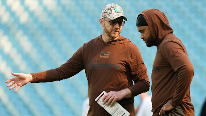 Miami Dolphins quarterback Tua Tagovailoa works with quarterbacks coordinator Darrell Bevell prior to the game against the Las Vegas Raiders at Hard Rock Stadium in 2023.
