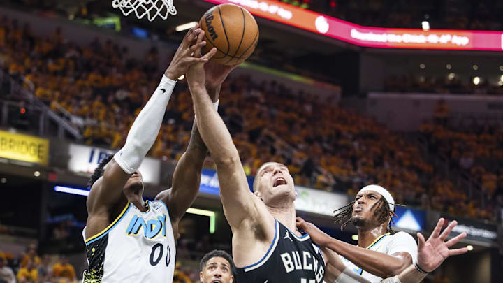 Apr 19, 2025; Indianapolis, Indiana, USA; Indiana Pacers guard Bennedict Mathurin (00) and Milwaukee Bucks center Brook Lopez (11) fight for a rebound in the first half at Gainbridge Fieldhouse. Mandatory Credit: Trevor Ruszkowski-Imagn Images Apr 19, 2025; Indianapolis, Indiana, USA; Indiana Pacers guard Bennedict Mathurin (00) and Milwaukee Bucks center Brook Lopez (11) fight for a rebound in the first half at Gainbridge Fieldhouse. Mandatory Credit: Trevor Ruszkowski-Imagn Images
