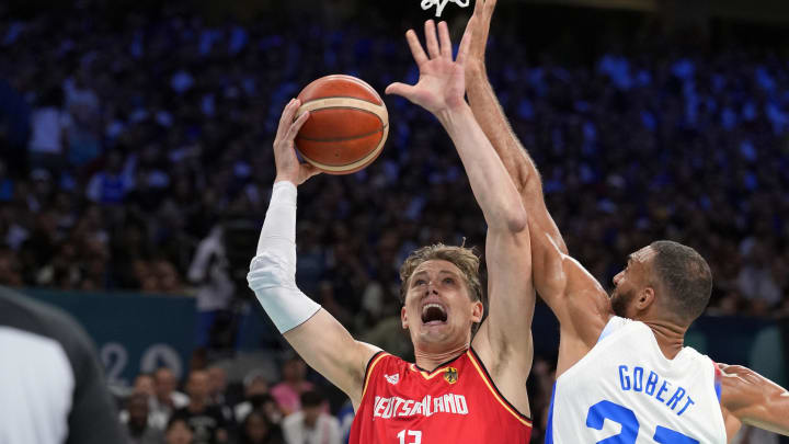 Aug 2, 2024; Villeneuve-d'Ascq, France; Germany forward Moritz Wagner (13) shoots against France centre Rudy Gobert (27) in the first half in a men’s group B basketball game during the Paris 2024 Olympic Summer Games at Stade Pierre-Mauroy. 