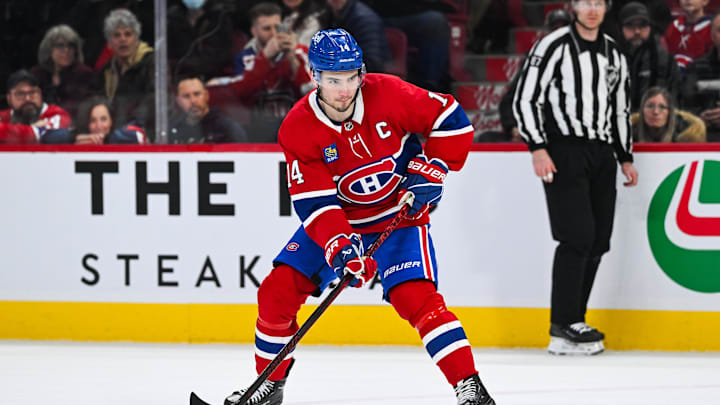 Mar 22, 2025; Montreal, Quebec, CAN; Montreal Canadiens center Nick Suzuki (14) plays the puck against the Colorado Avalanche in shootout at Bell Centre. Mandatory Credit: David Kirouac-Imagn Images