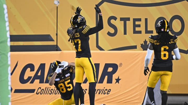 Jun 16, 2024; Hamilton, Ontario, CAN; Hamilton Tiger Cats wide receiver Shemar Bridge (17) celebrates a third quarter touchdown with wide receiver Kinder Smith (85) and wide receiver at Tim Dunbar Jr Hortons Field. Mandatory Credit: Gerry Angus-USA TODAY Sports