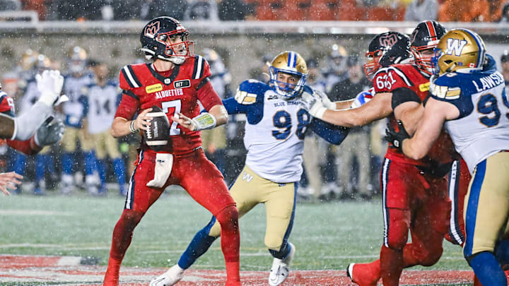 Jul 1, 2023; Montreal, Quebec, CAN; Montreal Alouettes quarterback Cody Fajardo (7) considers his options with the ball against the Winnipeg Blue Bombers during the fourth quarter at Percival Molson Memorial Stadium. Mandatory Credit: David Kirouac-Imagn Images