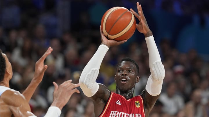 Aug 2, 2024; Villeneuve-d'Ascq, France; Germany point guard Dennis Schroder (17) shoots against France power forward Victor Wembanyama (32) in the first half in a men’s group B basketball game during the Paris 2024 Olympic Summer Games at Stade Pierre-Mauroy. Mandatory Credit: John David Mercer-USA TODAY Sports