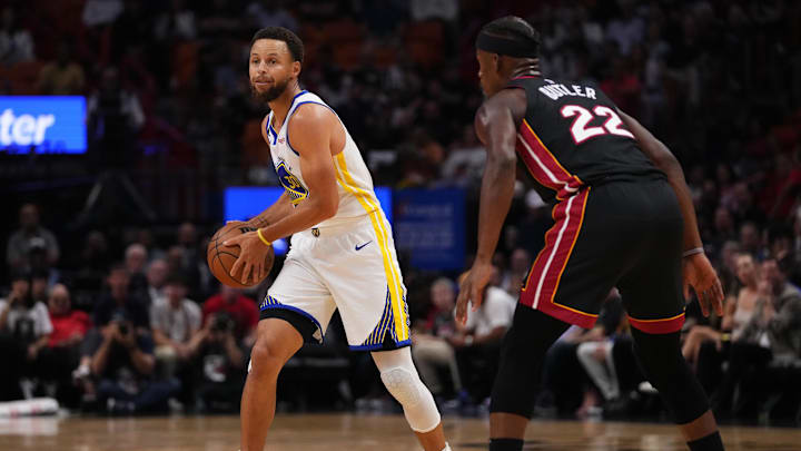 Golden State Warriors guard Stephen Curry (30) and Miami Heat forward Jimmy Butler (22) during the first half at FTX Arena.