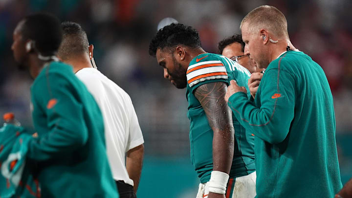 Sep 12, 2024; Miami Gardens, Florida, USA; Miami Dolphins quarterback Tua Tagovailoa (1) walks off the field with training staff after an apparent injury during the second half against the Buffalo Bills at Hard Rock Stadium.