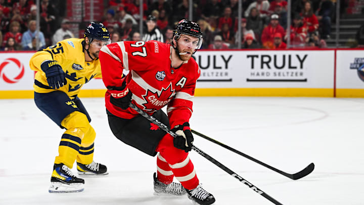Feb 12, 2025; Montreal, Quebec, CAN; [Imagn Images direct customers only] Team Canada forward Connor McDavid (97) plays the puck against Team Sweden defenseman Erik Karlsson (65) in the first period during a 4 Nations Face-Off ice hockey game at Bell Centre. 