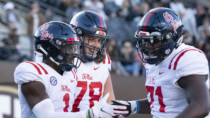 Oct 8, 2022; Nashville, Tennessee, USA;  Mississippi Rebels wide receiver Jonathan Mingo (1) celebrates withy teammates Jeremy James (78) and Jayden Williams (71) after a 71 yard touchdown catch against the Vanderbilt Commodores during the third quarter at FirstBank Stadium.  Mandatory Credit: George Walker IV - USA TODAY Sports