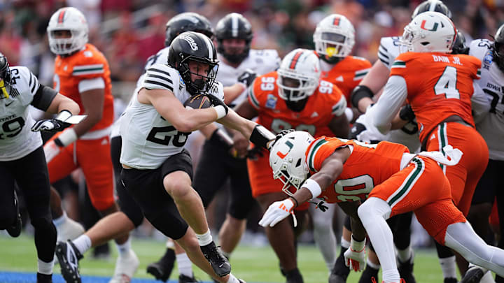 Iowa State Cyclones running back Carson Hansen stiff arms Miami Hurricanes defensive back Zaquan Patterson and Adarius Hayes Iowa State Cyclones running back Carson Hansen stiff arms Miami Hurricanes defensive back Zaquan Patterson and Adarius Hayes