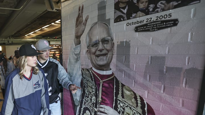 Fans walk by fandom of Pope Leo XIV with graphics before a baseball game between the Chicago White Sox and Texas Rangers at Rate Field. Fans walk by fandom of Pope Leo XIV with graphics before a baseball game between the Chicago White Sox and Texas Rangers at Rate Field.